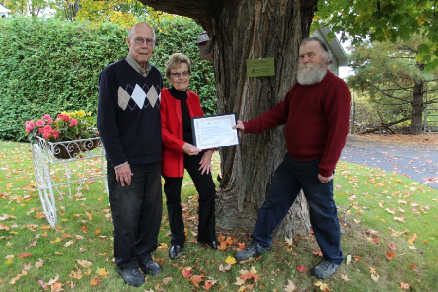 People holding plaque