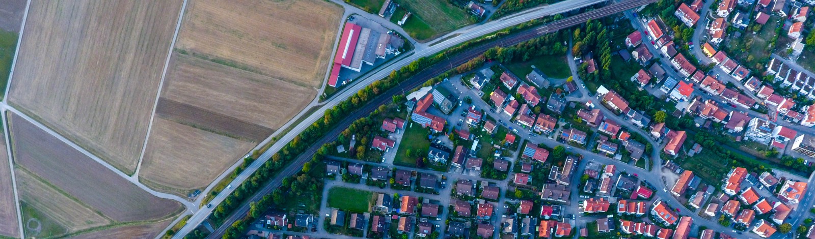 aerial view of farm adjacent to subdivision