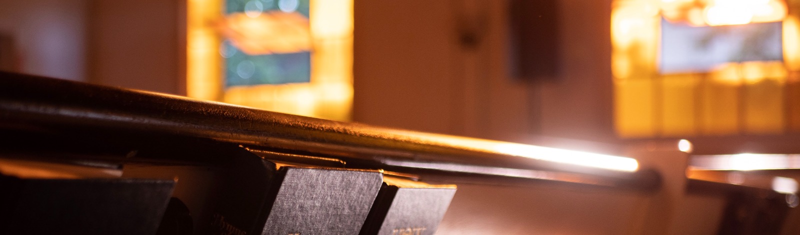 church pew with hymn books