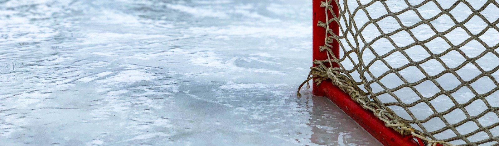 ice surface with red hockey net