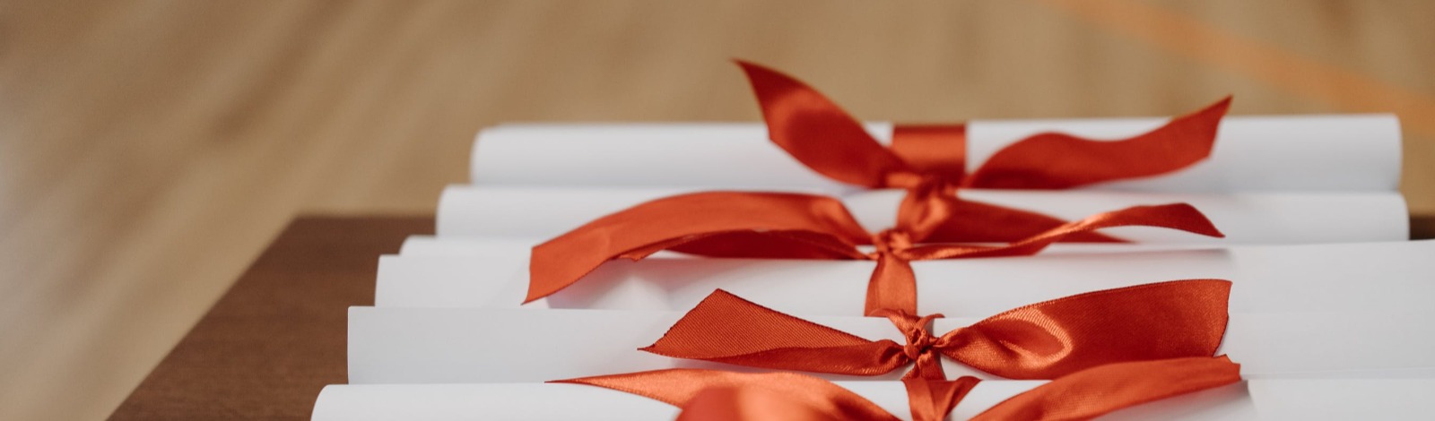 multiple scrolls of paper tied with ribbon