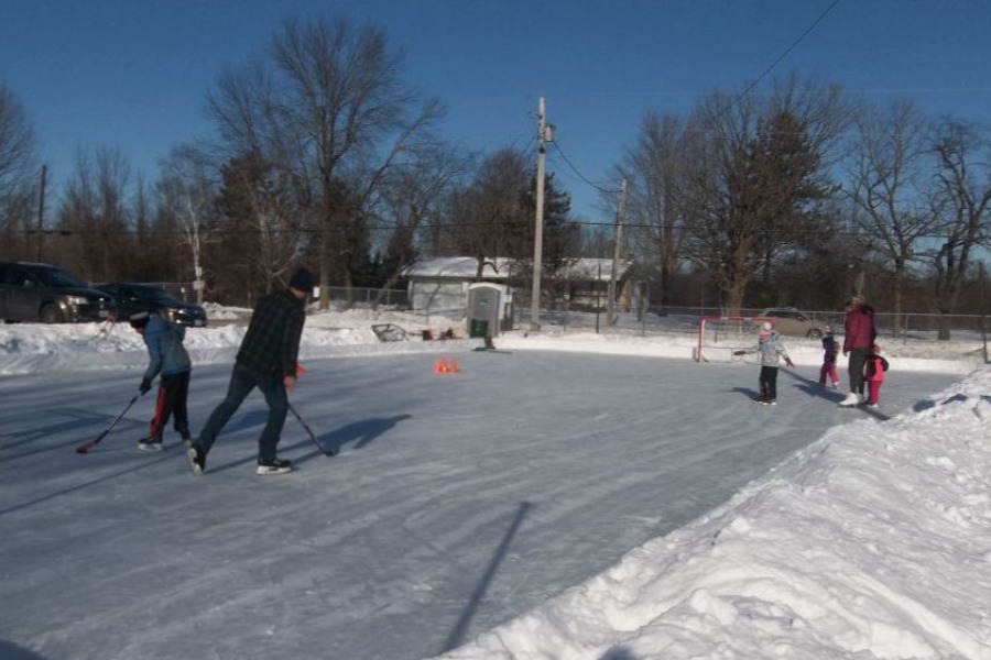 kids and adults playing hockey