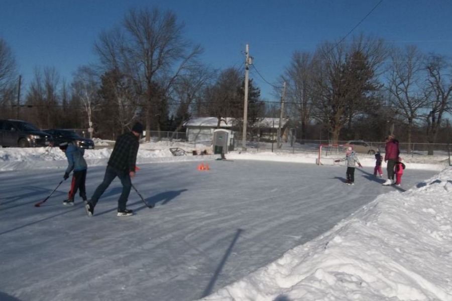 kids and adults playing hockey