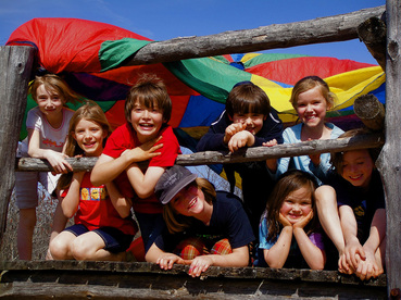 Kids smiling in an outside play structure