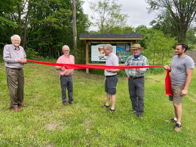 Deputy Reeve Barrie Crampton, Reeve Brian Campbell, Jim Tysick (who helped name the park), Councillor Rob Rainer, and the son of Jim Tysick cutting the ribbon