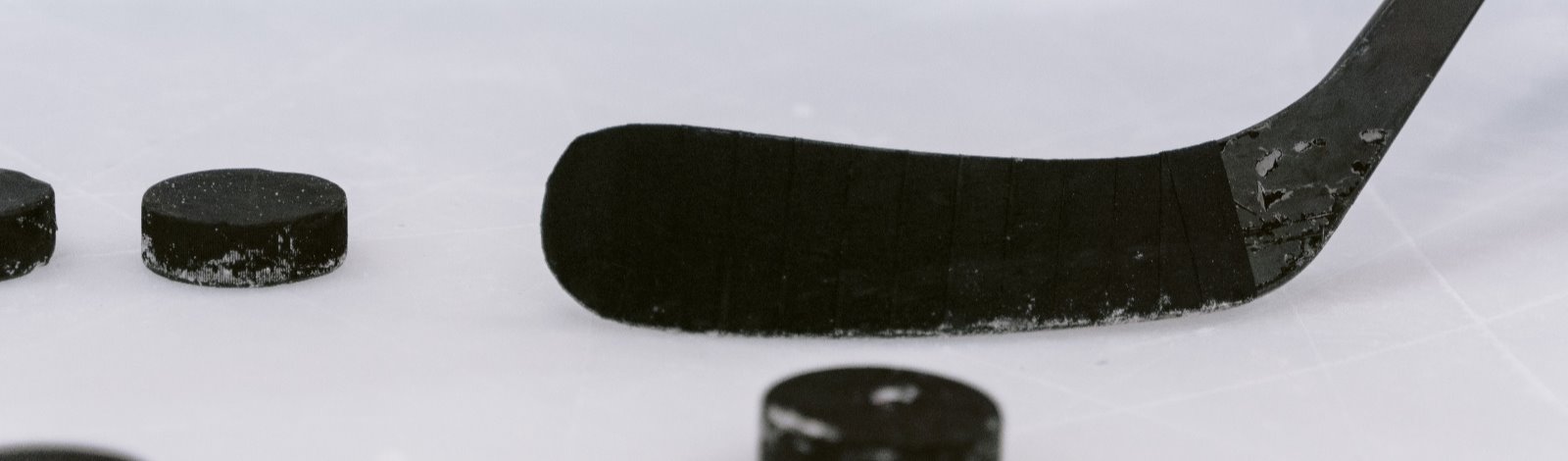 hockey stick with pucks