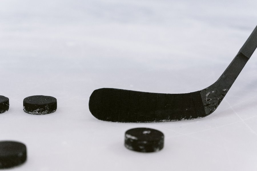 hockey stick and puck on the ice