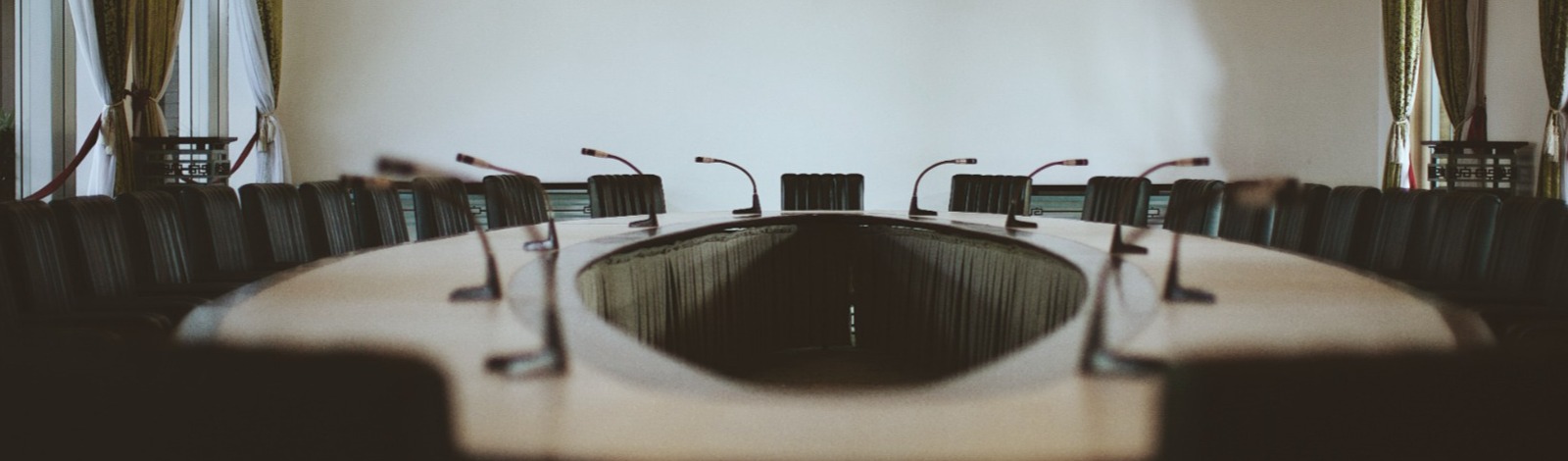 black chairs around boardroom table  