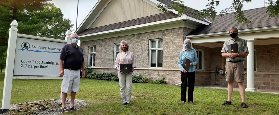 Four people in front of buidlng