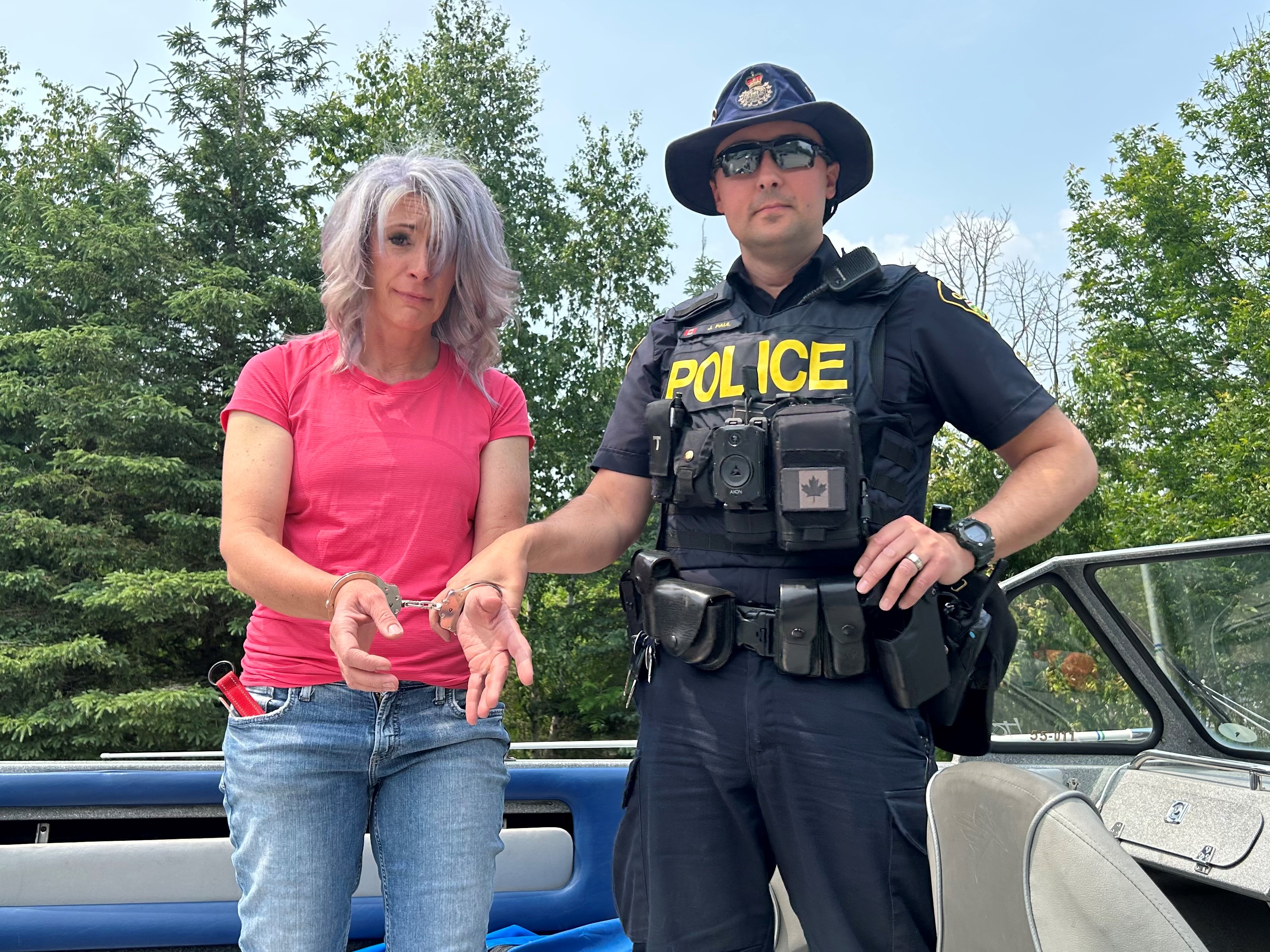 Councillor Jordan being placed in handcuffs