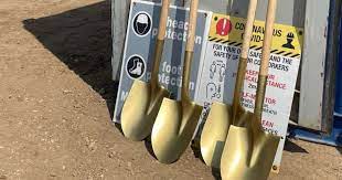 shovels leaning against signs