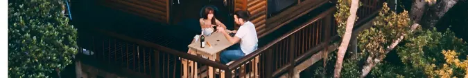 A couple sitting on a deck 